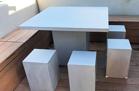 A concrete outdoor table manufactured in the shop and delivered to the customer